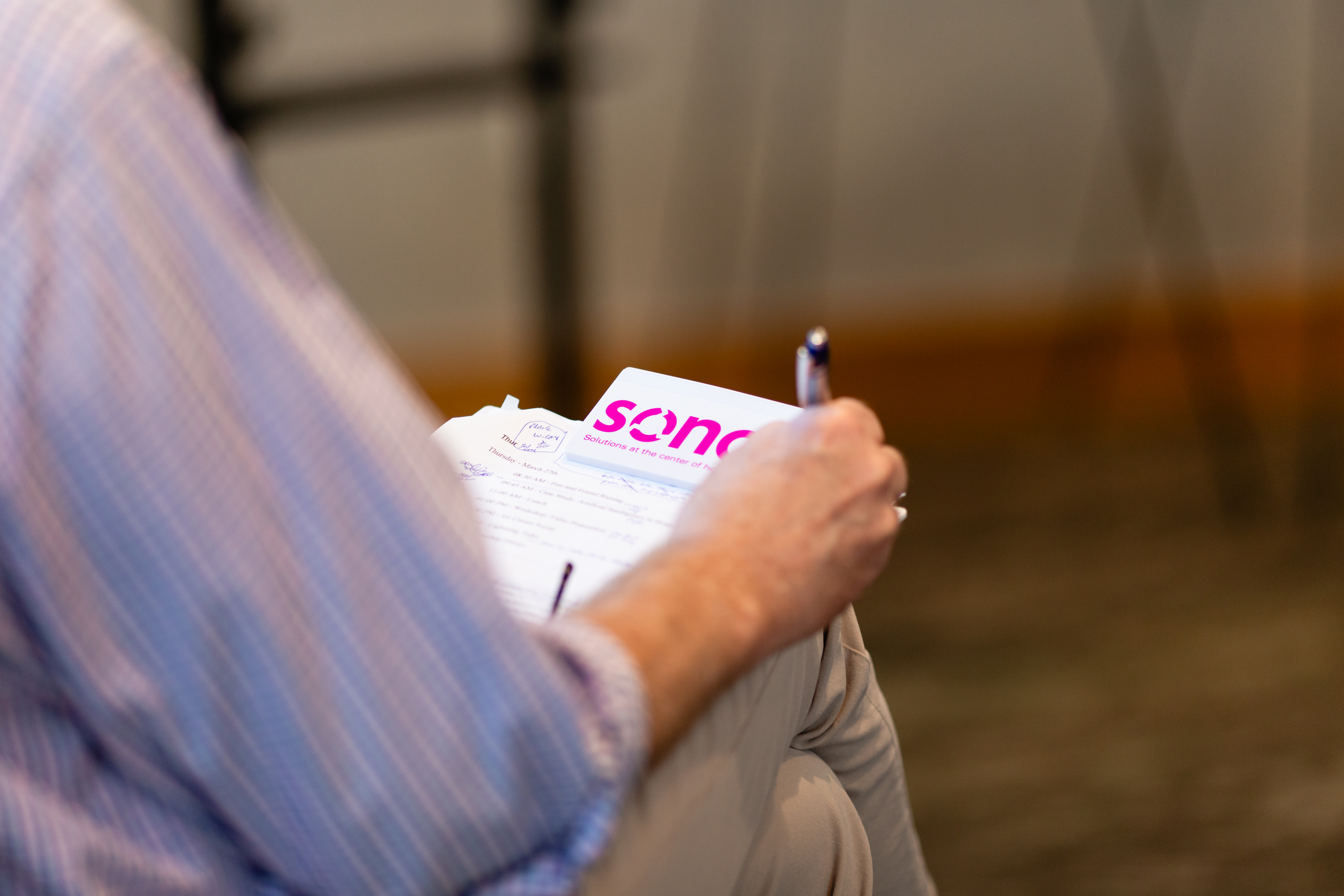 Attendee taking notes at a SONO industry partner session